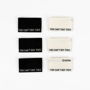 Set of six rectangular stickers with 'You Can't Buy This' text on a white background.